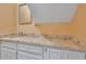 Bathroom vanity features a light granite countertop, white cabinets, and a framed mirror at 1652 Lauda Dr, Mount Pleasant, SC 29464