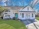 Charming single-Gathering home with a well-manicured lawn, bright turquoise front door, and white picket fence at 1652 Lauda Dr, Mount Pleasant, SC 29464