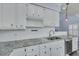 Bright kitchen featuring light granite countertops, white cabinets, and stainless steel appliances with modern fixtures at 1652 Lauda Dr, Mount Pleasant, SC 29464