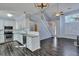 Open-concept kitchen with white cabinets, stainless steel appliances, and granite countertops leading to a spacious living area at 1652 Lauda Dr, Mount Pleasant, SC 29464