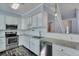 Contemporary kitchen with white cabinetry, stainless steel appliances, light countertops, and modern fixtures and lighting at 1652 Lauda Dr, Mount Pleasant, SC 29464