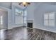 Living room with high ceilings, large windows, white shutters, and a fireplace with modern dark wood floors at 1652 Lauda Dr, Mount Pleasant, SC 29464