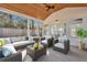 Cozy screened patio furnished with sofa, chairs, ceiling fan and wood ceiling at 1652 Lauda Dr, Mount Pleasant, SC 29464