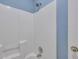 Clean and bright shower with white surround and blue accent wall in the bathroom at 1652 Lauda Dr, Mount Pleasant, SC 29464