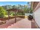 Covered brick patio featuring an outdoor kitchen area and an extended backyard at 1694 Jedburg Rd, Summerville, SC 29486