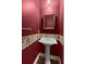 Elegant powder room featuring stylish sink, mirror, and red painted walls at 1694 Jedburg Rd, Summerville, SC 29486