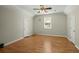 Neutral bedroom with ceiling fan, natural light from a window, and hardwood flooring at 1694 Jedburg Rd, Summerville, SC 29486