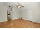 Large bedroom featuring a ceiling fan, hardwood floors, and two entry doors at 1694 Jedburg Rd, Summerville, SC 29486