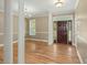 Bright entryway featuring hardwood floors, classic columns, and a solid wood front door with sidelights at 1694 Jedburg Rd, Summerville, SC 29486