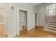 Hallway view with staircase, open closets, and hardwood floors at 1694 Jedburg Rd, Summerville, SC 29486