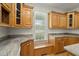 Kitchen with wooden cabinets, granite countertops, a window seat, and natural light at 1694 Jedburg Rd, Summerville, SC 29486