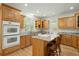 Classic kitchen with wooden cabinets, granite countertops, stainless appliances, and central island with bar stool seating at 1694 Jedburg Rd, Summerville, SC 29486