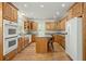 Traditional kitchen featuring wood cabinets, stainless steel appliances, a central island, and hardwood floors at 1694 Jedburg Rd, Summerville, SC 29486