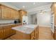 Spacious kitchen island with cooktop and seating, surrounded by wooden cabinetry and views into other rooms at 1694 Jedburg Rd, Summerville, SC 29486