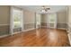 Spacious living room with gleaming hardwood floors, crown molding, large windows and natural light at 1694 Jedburg Rd, Summerville, SC 29486
