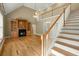 Open-concept living space with fireplace, staircase, and hardwood flooring at 1694 Jedburg Rd, Summerville, SC 29486