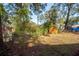 The backyard features a wooden shed and is surrounded by mature trees and greenery at 20 Stratton Dr, Charleston, SC 29420