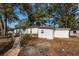Exterior view of the home with an outbuilding and mature trees surrounding the property at 20 Stratton Dr, Charleston, SC 29420