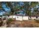 Exterior view of the home with a separate outbuilding and mature trees surrounding the property at 20 Stratton Dr, Charleston, SC 29420