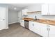 Modern kitchen featuring white cabinets, butcher block countertops, and stainless steel appliances at 20 Stratton Dr, Charleston, SC 29420