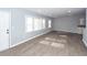 Bright living room features several windows, modern floors, and access to other rooms at 20 Stratton Dr, Charleston, SC 29420