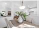 Open-concept dining area with views into the living room and kitchen, featuring modern decor and plenty of natural light at 229 Night Heron St # 602, Summerville, SC 29486