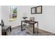 Home office space with a modern desk and chair offers plenty of natural light from a large window at 229 Night Heron St # 602, Summerville, SC 29486