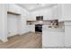 Open kitchen featuring white cabinets, stainless steel appliances, subway tile backsplash, and modern light fixtures at 229 Night Heron St # 602, Summerville, SC 29486