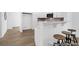 Bright kitchen showcasing white cabinetry, stainless steel appliances, breakfast bar and expansive gray countertops at 229 Night Heron St # 602, Summerville, SC 29486
