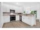 Modern kitchen featuring stainless steel appliances, white cabinets, stylish backsplash, and light-filled adjacent dining area at 229 Night Heron St # 602, Summerville, SC 29486