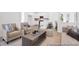 Open-concept living room features white trim, neutral walls, light-colored wood floors, and modern furniture at 229 Night Heron St # 602, Summerville, SC 29486