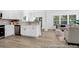Open-concept kitchen and living area with hardwood floors, modern finishes, and plenty of natural light at 229 Night Heron St # 602, Summerville, SC 29486