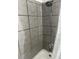 Bathroom shower with gray tiled walls, a shower head, and a white tub, complemented by a shower curtain at 233 N Pandora Dr, Goose Creek, SC 29445