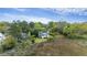An aerial view of a lovely home with a gray roof, surrounded by vibrant trees and marshland at 2345 Waring Hall Ln, Charleston, SC 29414