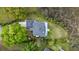 An aerial view of a lovely home with a gray roof, surrounded by vibrant trees and marshland at 2345 Waring Hall Ln, Charleston, SC 29414