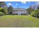 Expansive backyard view of the deck on this beautiful two-story home with green grass at 2345 Waring Hall Ln, Charleston, SC 29414