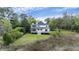 Backyard view of a lovely two story home showing greenery and trees surrounding the property at 2345 Waring Hall Ln, Charleston, SC 29414