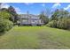 Expansive backyard view of the deck on this beautiful two-story home with green grass at 2345 Waring Hall Ln, Charleston, SC 29414