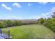The large grassy backyard offers an expansive view of the marsh, trees, and blue skies at 2345 Waring Hall Ln, Charleston, SC 29414