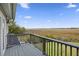 Enjoy the marsh views from this private, sunny balcony on a clear day with blue skies and fluffy white clouds at 2345 Waring Hall Ln, Charleston, SC 29414