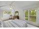 Inviting bedroom with hardwood floors, ceiling fan, dresser, and large windows with views at 2345 Waring Hall Ln, Charleston, SC 29414