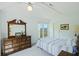 Light-filled bedroom with vaulted ceiling, dresser, and window offering scenic outdoor views at 2345 Waring Hall Ln, Charleston, SC 29414