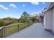 The spacious wooden deck has railings and a view of the yard, trees, marsh, and blue skies at 2345 Waring Hall Ln, Charleston, SC 29414