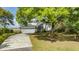 Picturesque home surrounded by lush greenery with a long driveway and a spacious two-car garage at 2345 Waring Hall Ln, Charleston, SC 29414