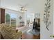 Bright living room with hardwood floors, ceiling fan, and sliding doors to balcony with scenic views at 2345 Waring Hall Ln, Charleston, SC 29414