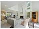 Spacious living room with soaring ceilings, a fireplace, and an open layout connecting to the dining area at 2345 Waring Hall Ln, Charleston, SC 29414