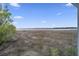 A window frames the marsh, trees, and blue skies, offering a scenic and tranquil outdoor view at 2345 Waring Hall Ln, Charleston, SC 29414
