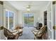 Relaxing sitting room with ceiling fan and sliding glass doors opening to scenic outdoor balcony at 2345 Waring Hall Ln, Charleston, SC 29414