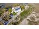 Expansive aerial view of a luxurious home with solar panels, surrounded by lush trees and waterfront scenery at 2480 Royal Oak Dr, Johns Island, SC 29455