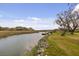 View of a gorgeous backyard with a dock and lush marshland at 2480 Royal Oak Dr, Johns Island, SC 29455